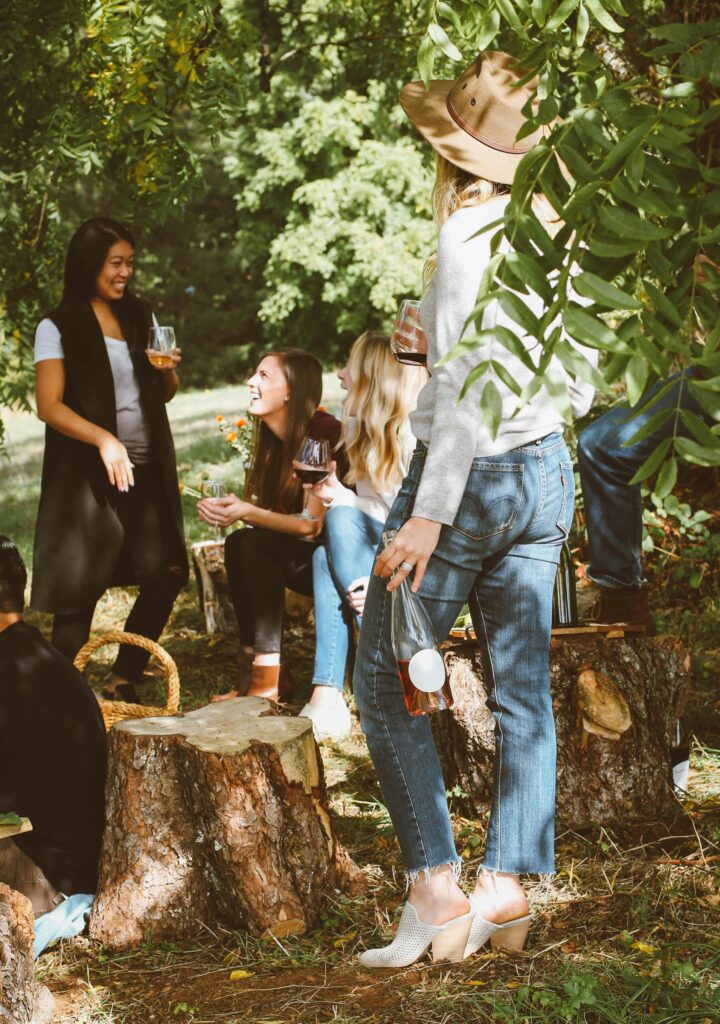 Hosting a dinner party with a group of friends outdoors and on a farm.