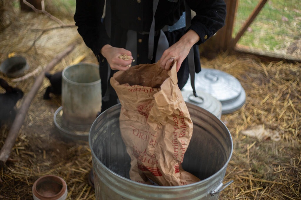 Image of giant rolled bag of rolled oats in a metal food bin.