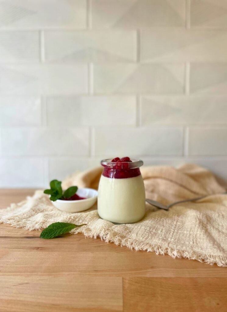 A 45 degree image of my panna cotta with raspeberry sauce and mint.