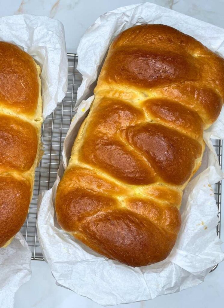 My traditional buttery brioche bread recipe shown as a bird's eye view (both braided and as rolls).